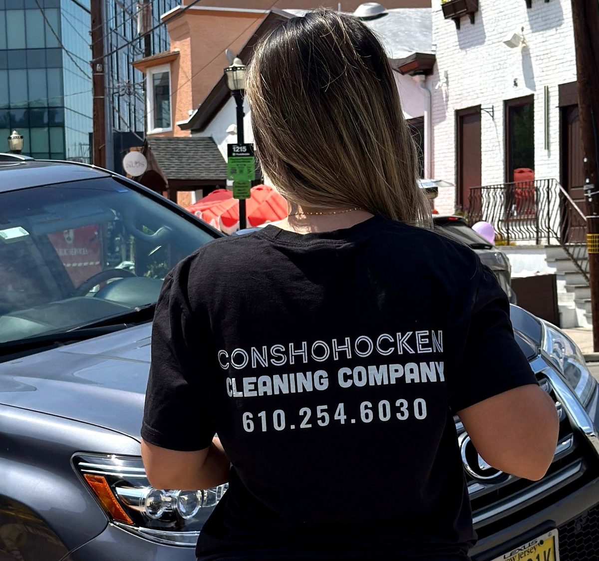 Conshohocken Cleaning Company team member in a branded company shirt on a Conshohocken street